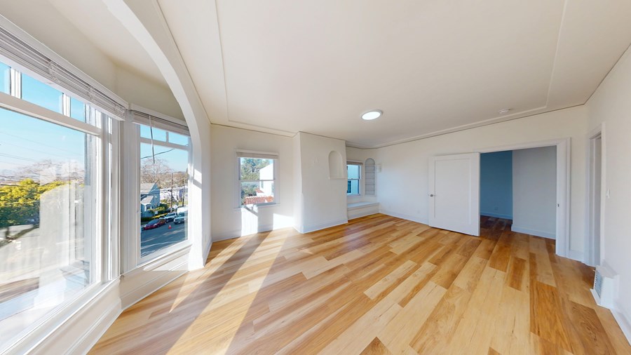 A room with wooden floors and white walls.